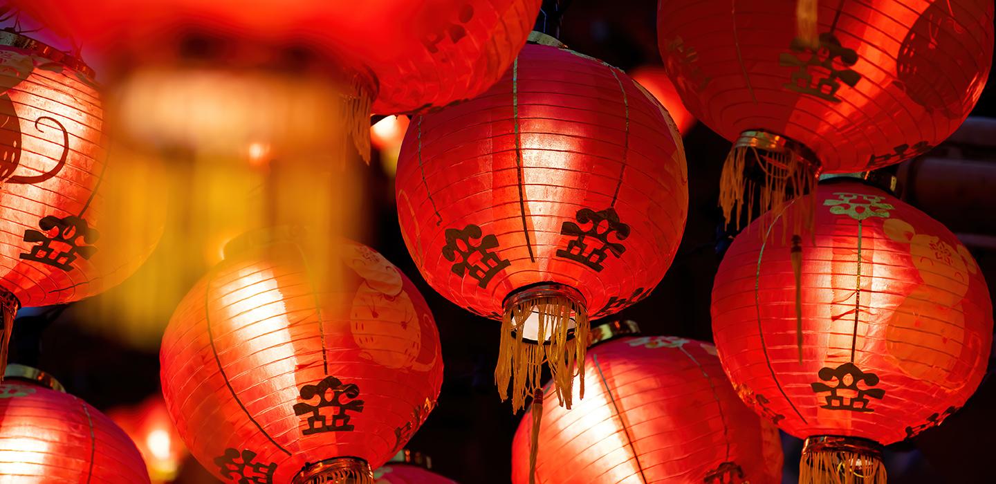 Multiple red lanterns lit up in the dark to celebrate the Lunar New Year. 