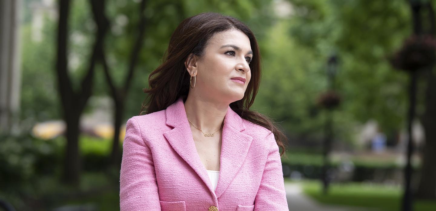 Nadine Melhem standing outside with pink jacket