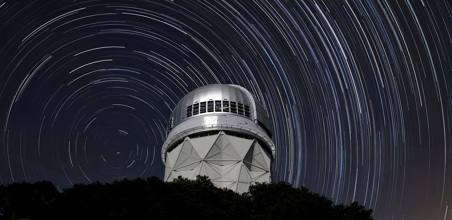 Star trails shown over an observatory at night