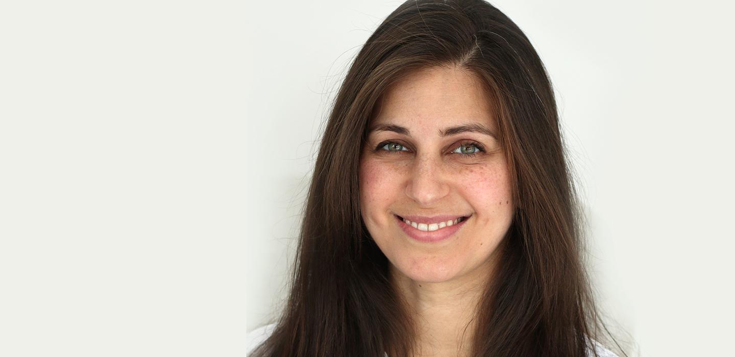 Karina Schumann smiling in front of white background