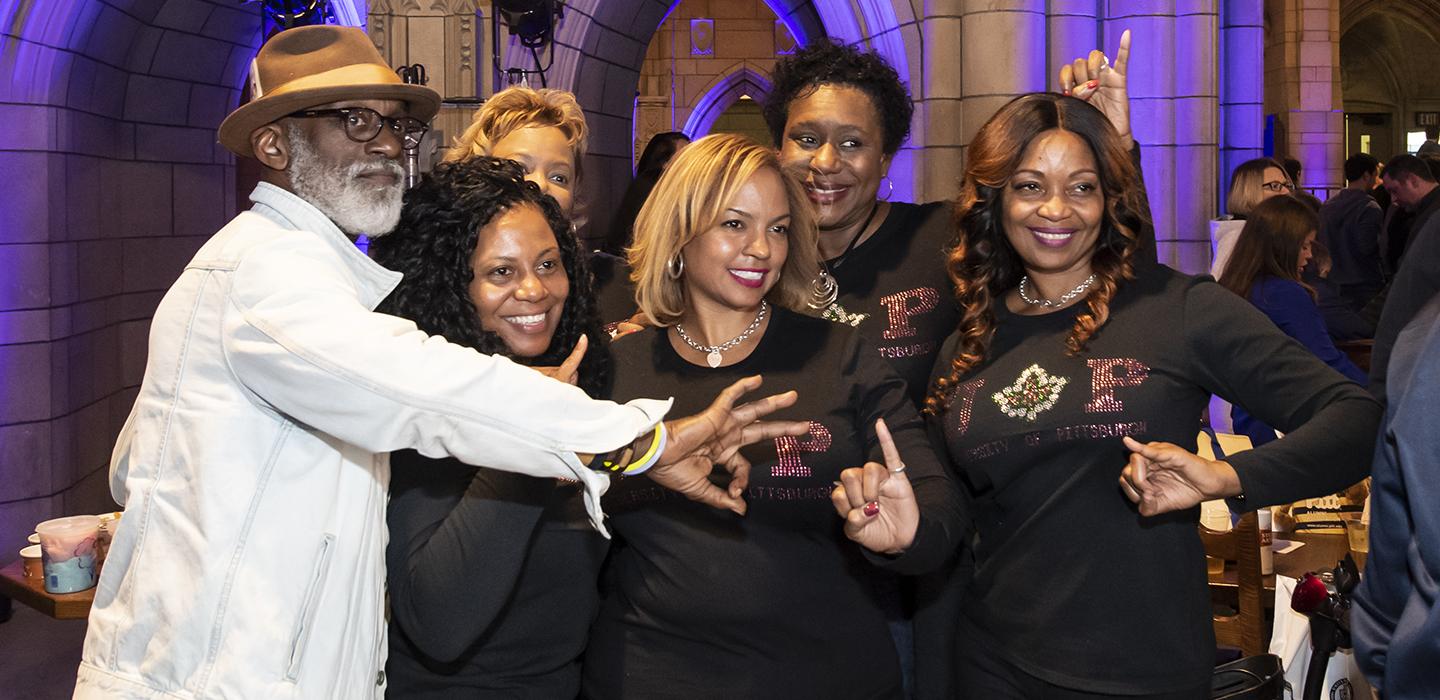 People gathered in the Cathedral of Learning wearing black shirts
