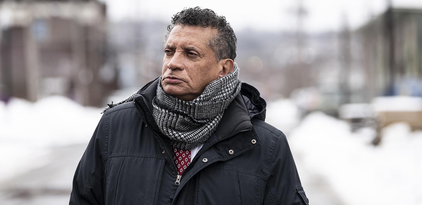 Tim Stevens standing outside wearing black coat during winter