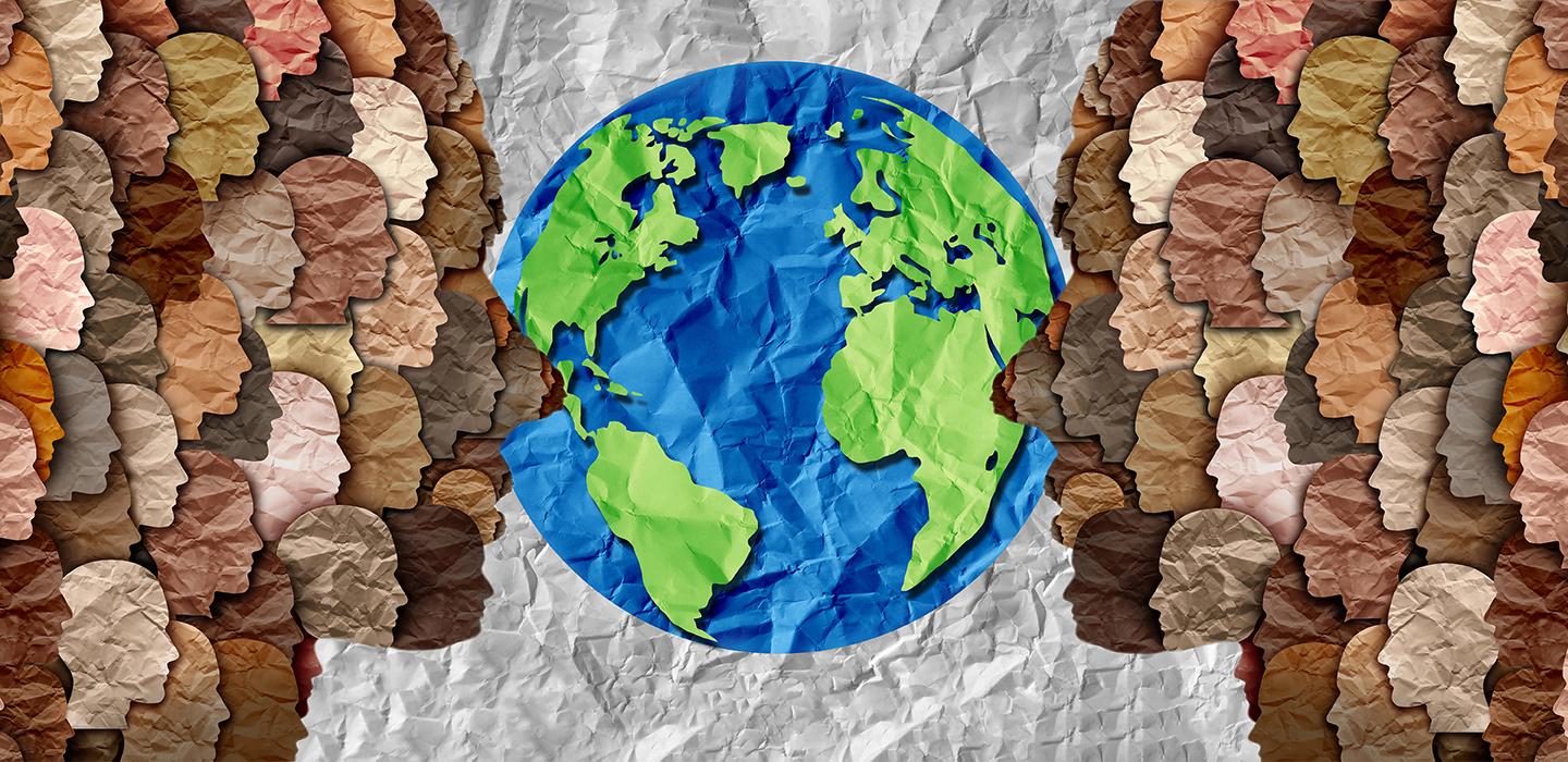 Colorful paper artwork of heads pointing towards earth