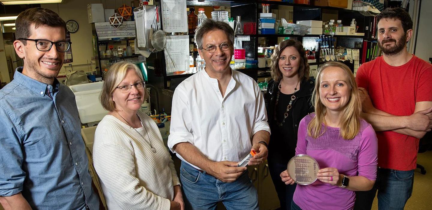 Hatfull Lab researchers standing together and smiling.