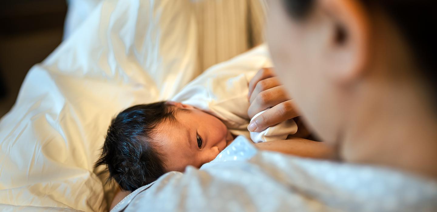 Mother holding baby in blanket