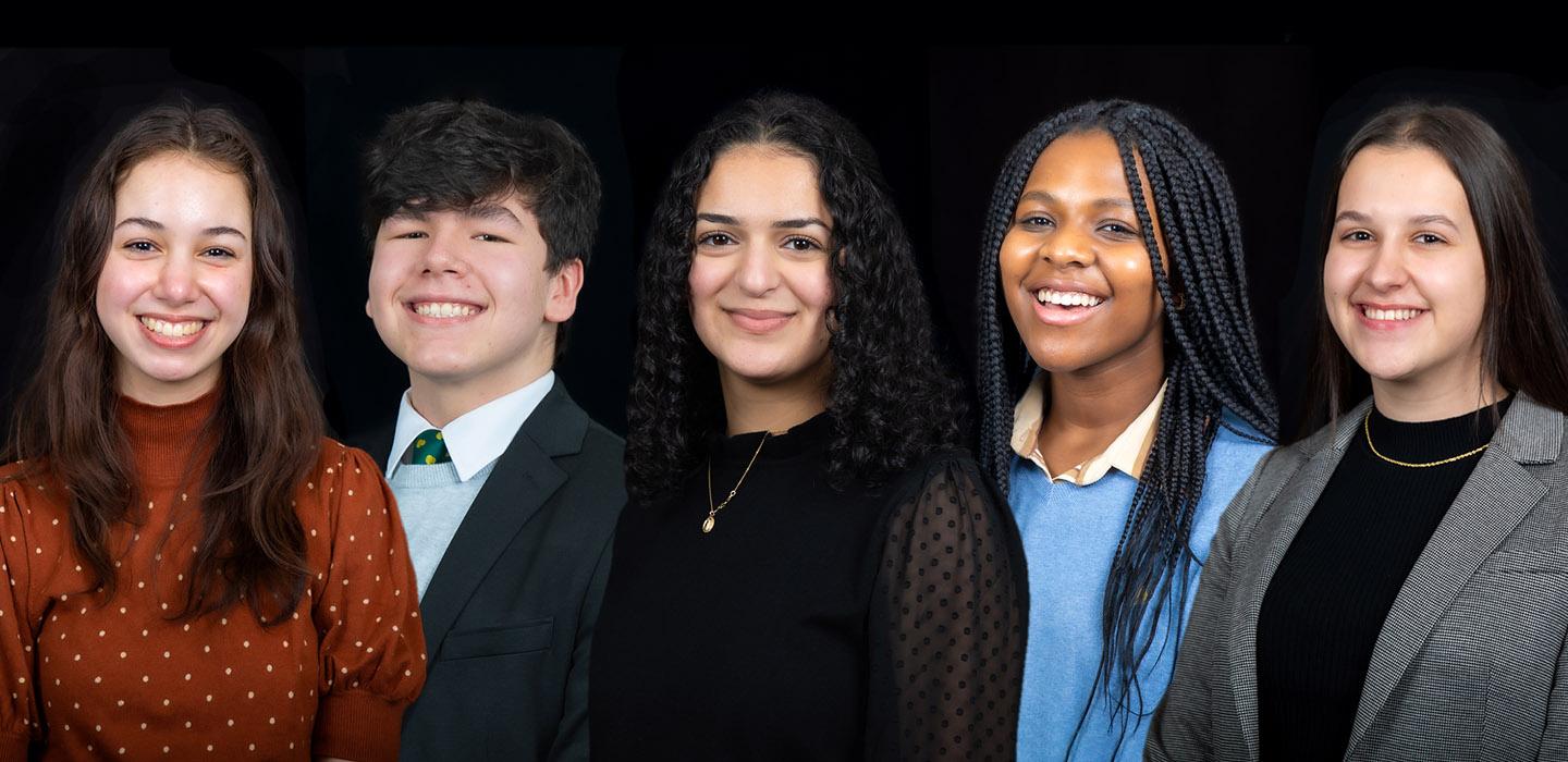 Five Stamps Scholars smiling in front of black background
