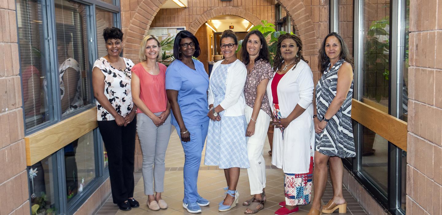 seven women posing together