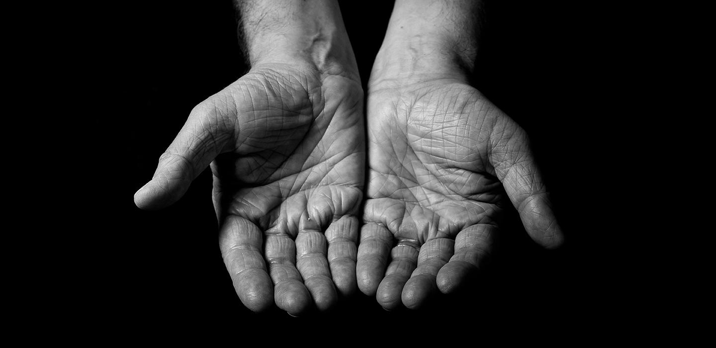 a black and white image of two open hands