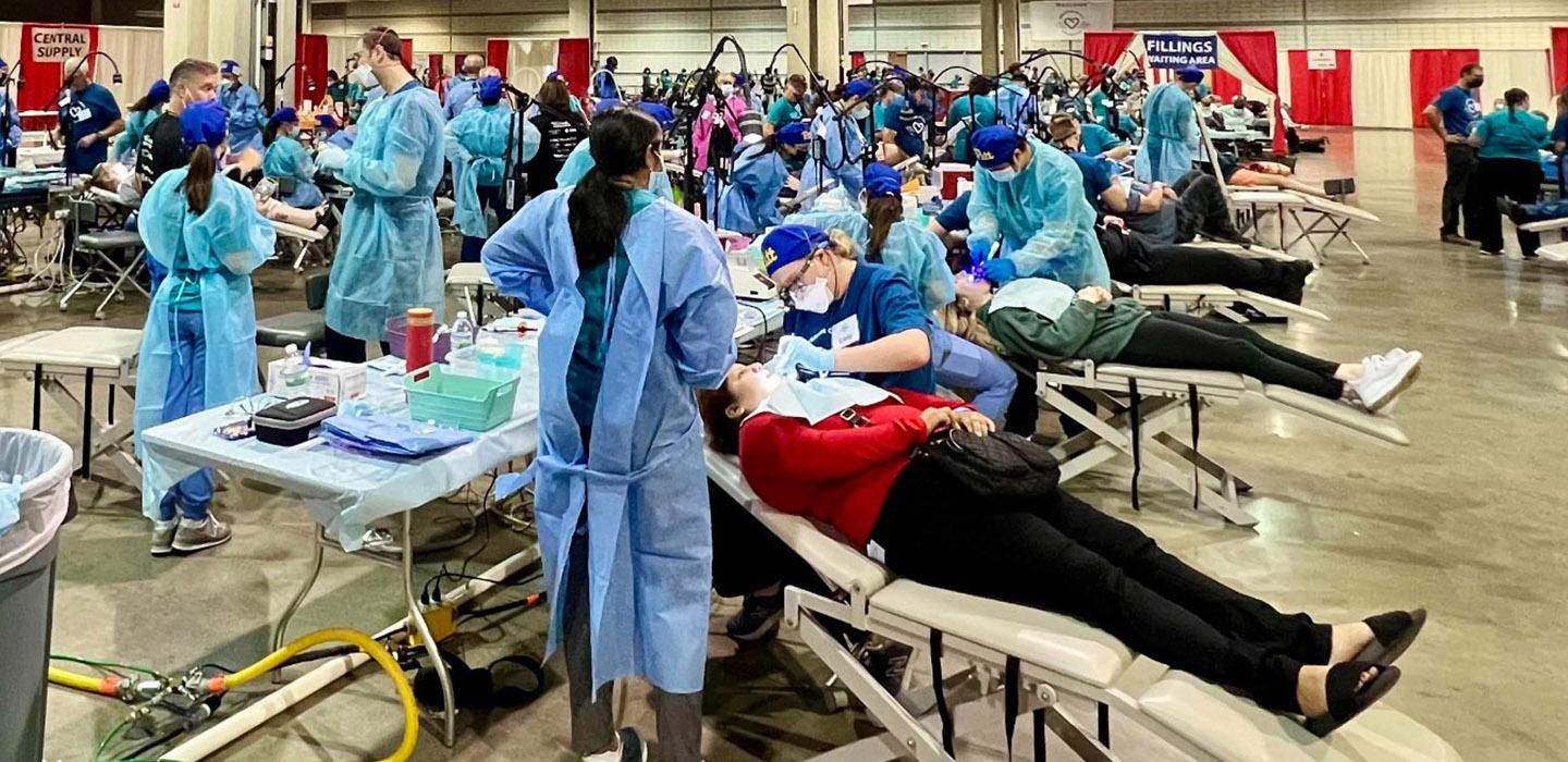 a large room with patients receiving dental care