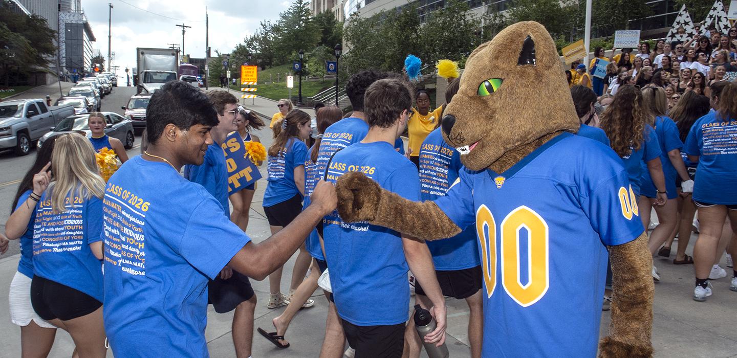 Roc giving a student a fist bump