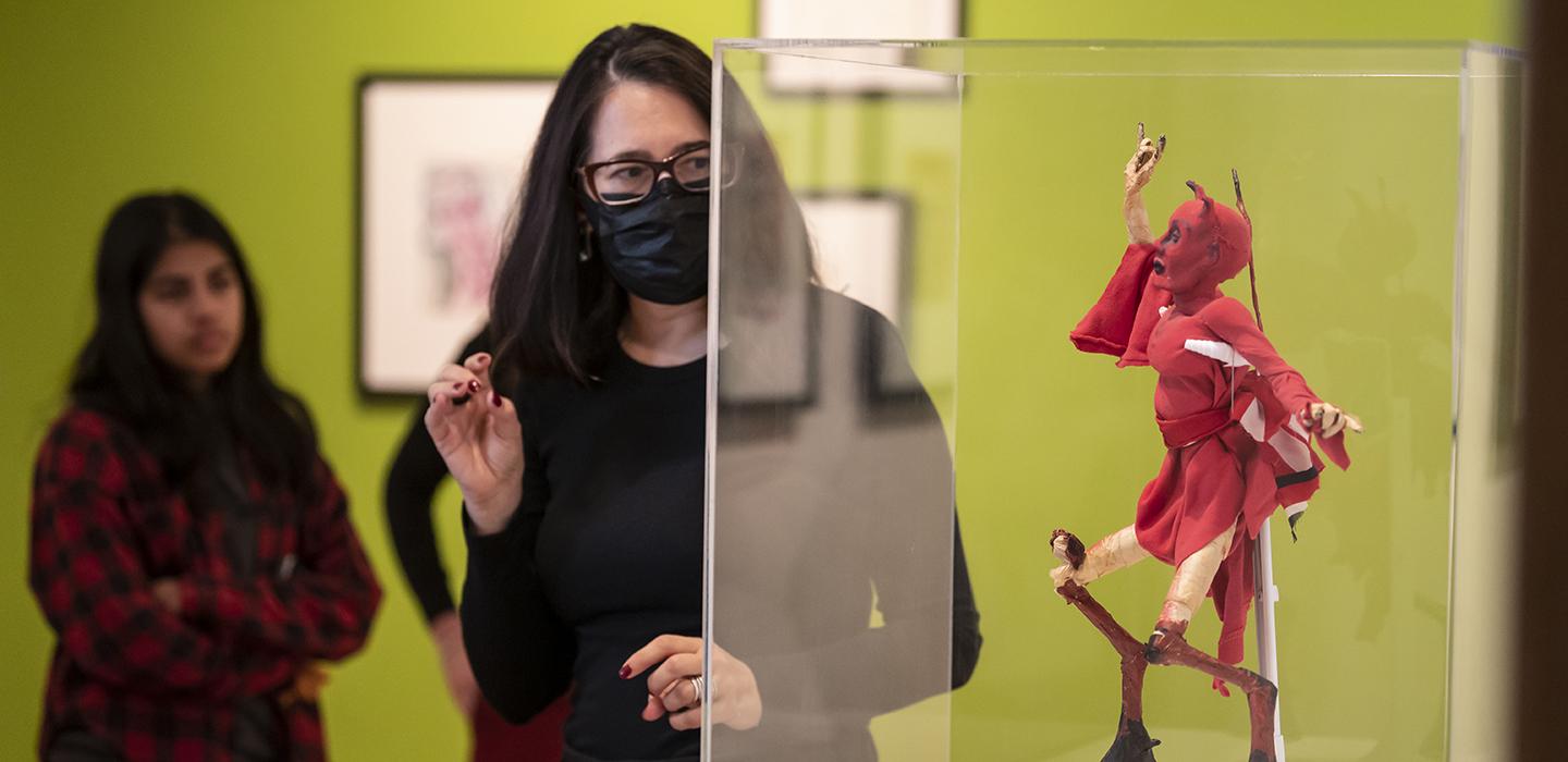 a woman looks at art