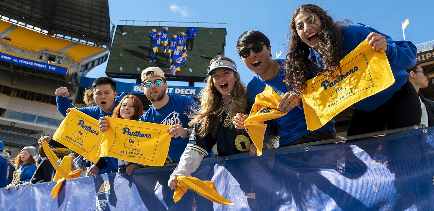 students cheer at homecoming football game