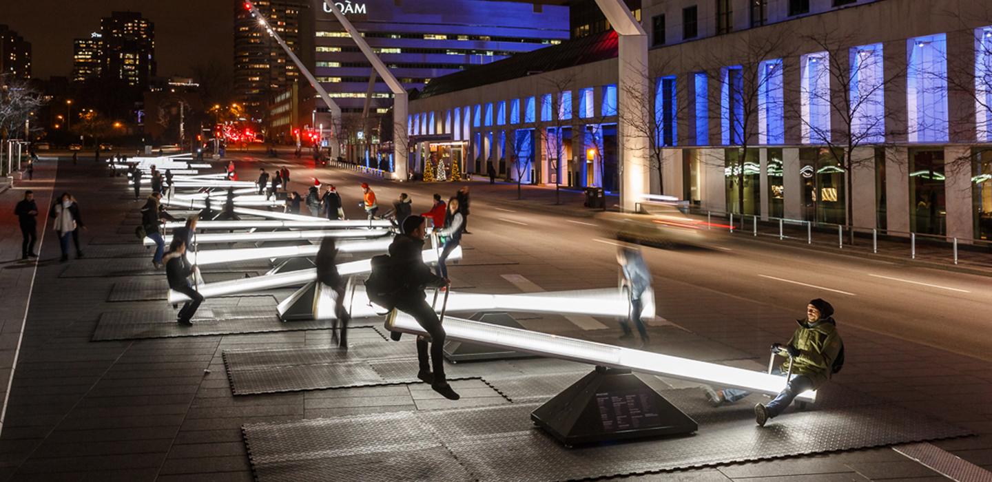 people playing on many illuminated seesaws