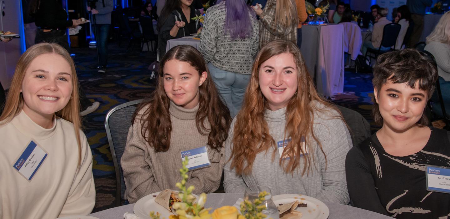 four students at a table