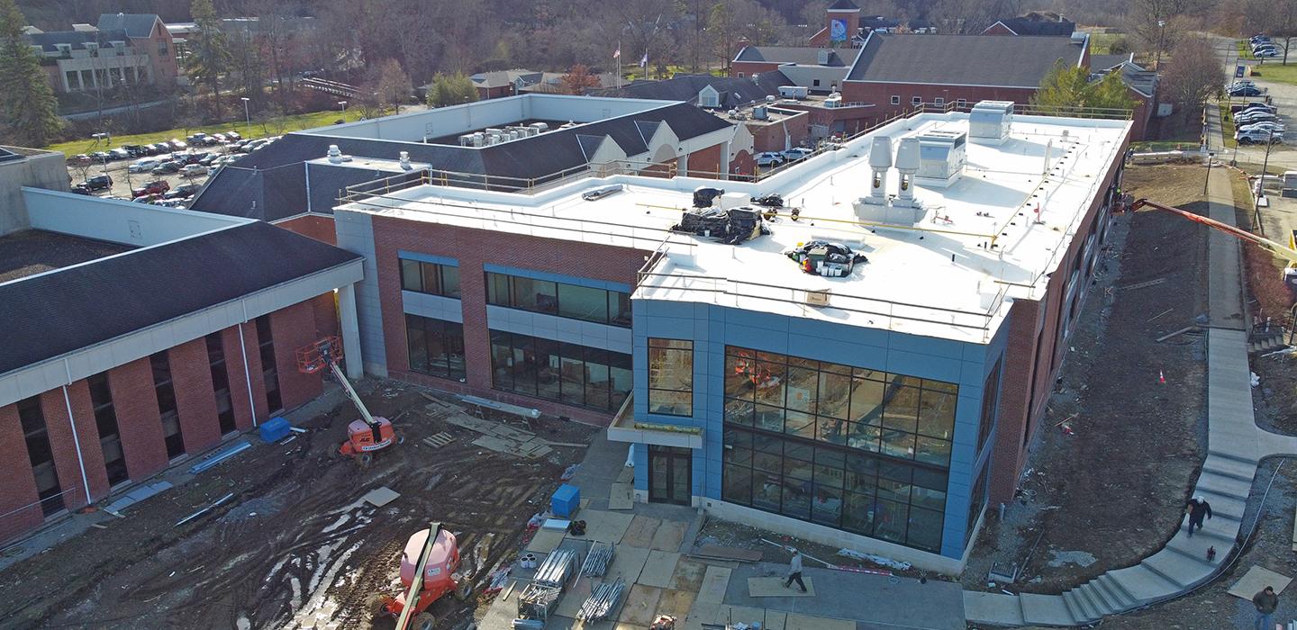 A drone shot shows construction machines working on the Life Sciences Building