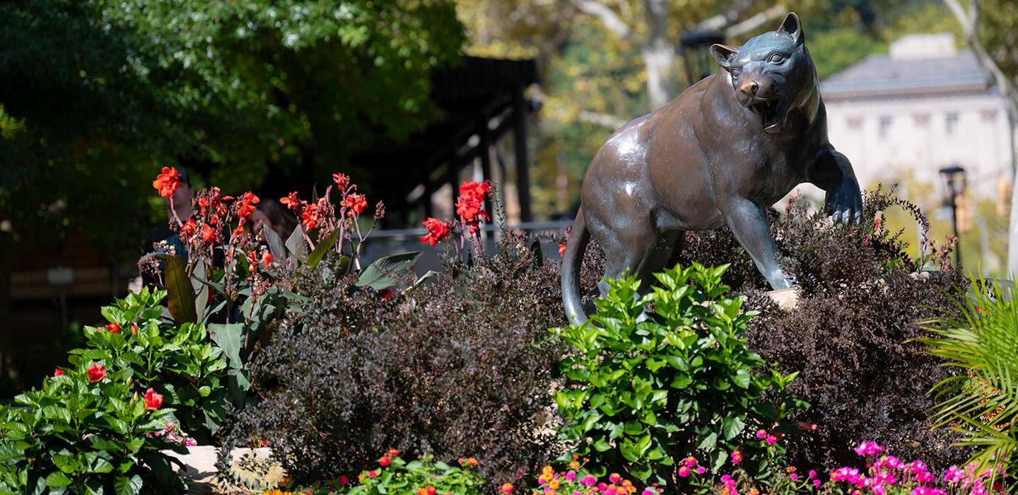A panther statue surrounded by plants