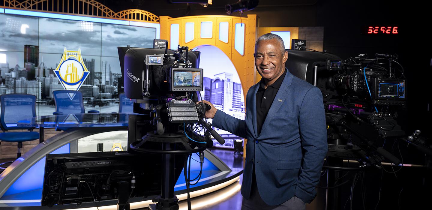Smith next to a camera in Pitt Studios