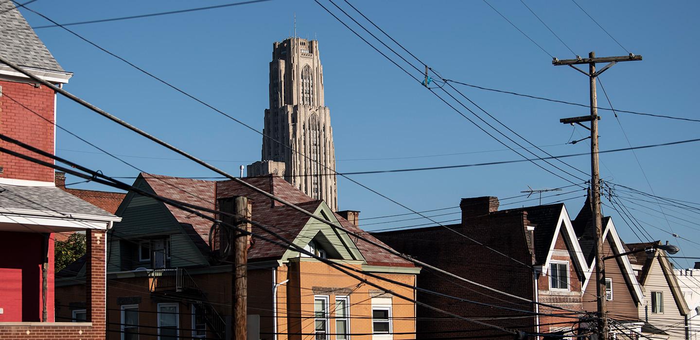 The Cathedral of Learning is seen over rooftops in a Pittsburgh neighborhood