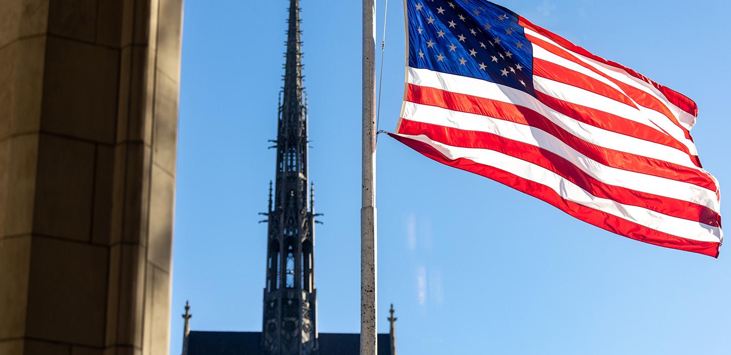An American flag flies with Heinz Memorial Chapel in the background