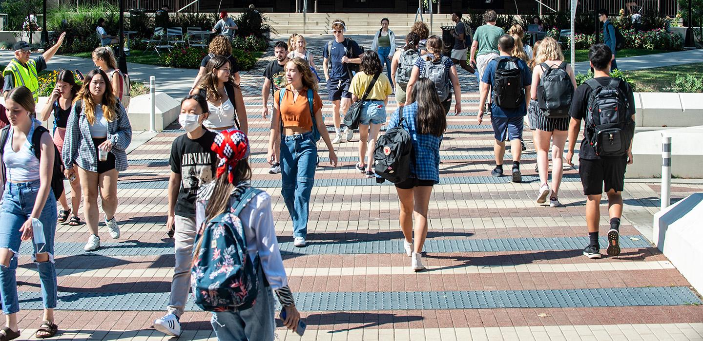 People walk on a crosswalk