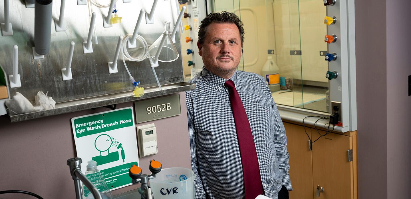 Duprex stands in his lab