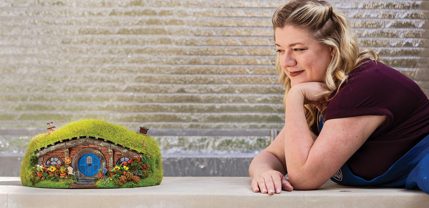 Darcy Prevost gazes at a miniature cottage she built