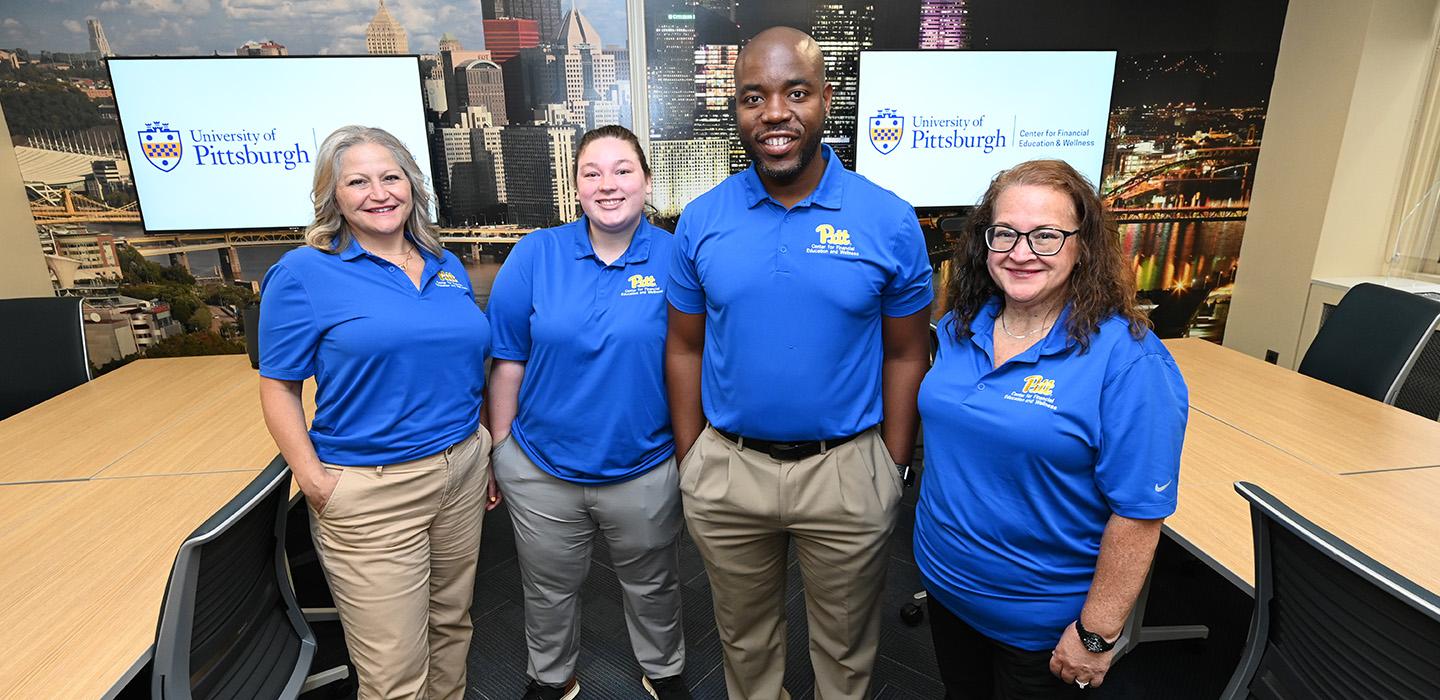 Four employees stand in Pitt's Center for Financial Education and Wellness