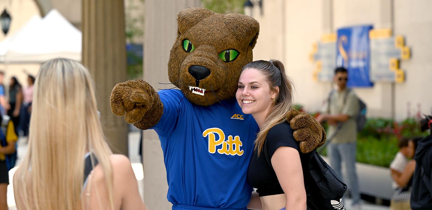 a student poses with Roc