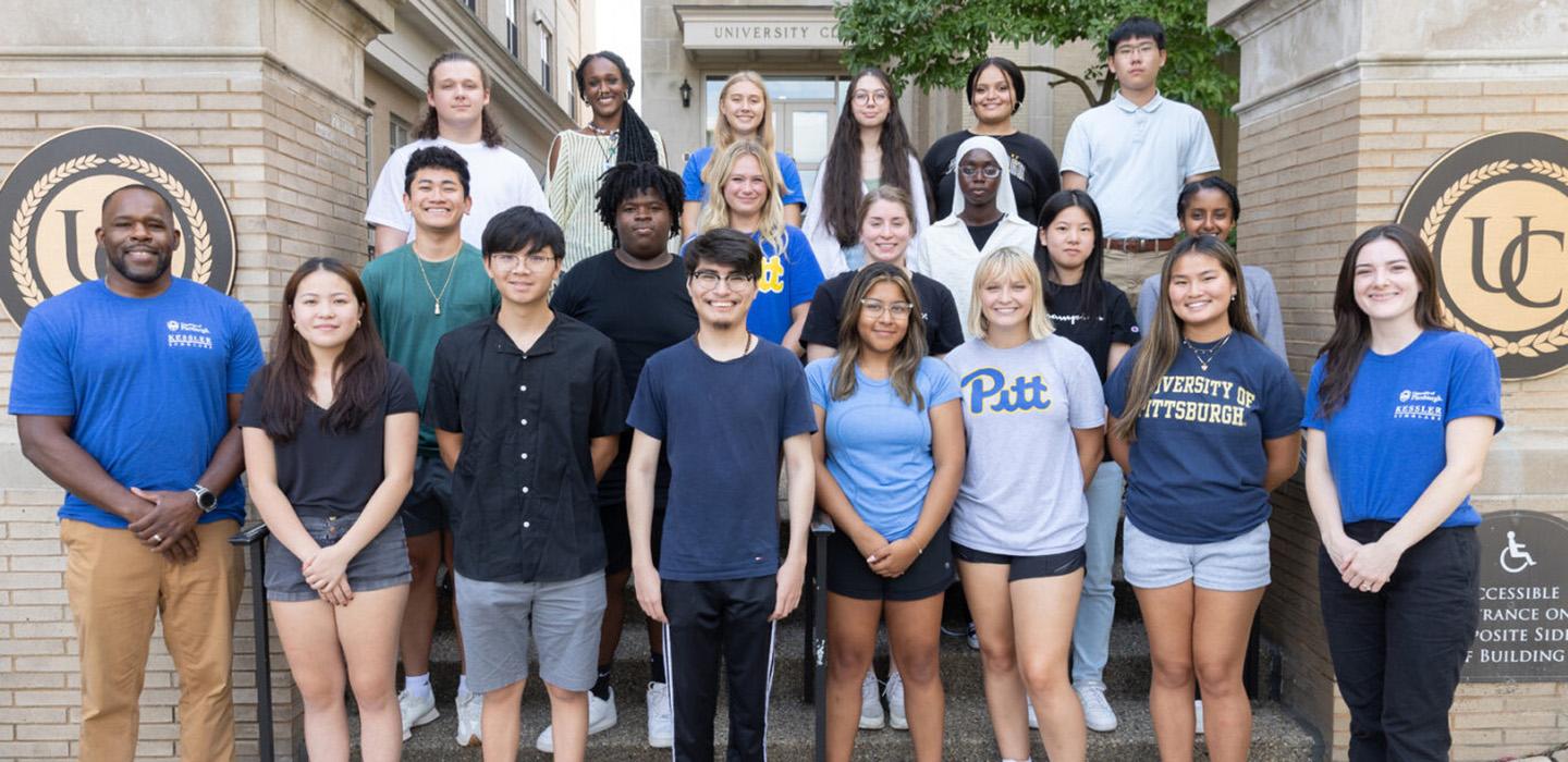 A group of students stand on stairs