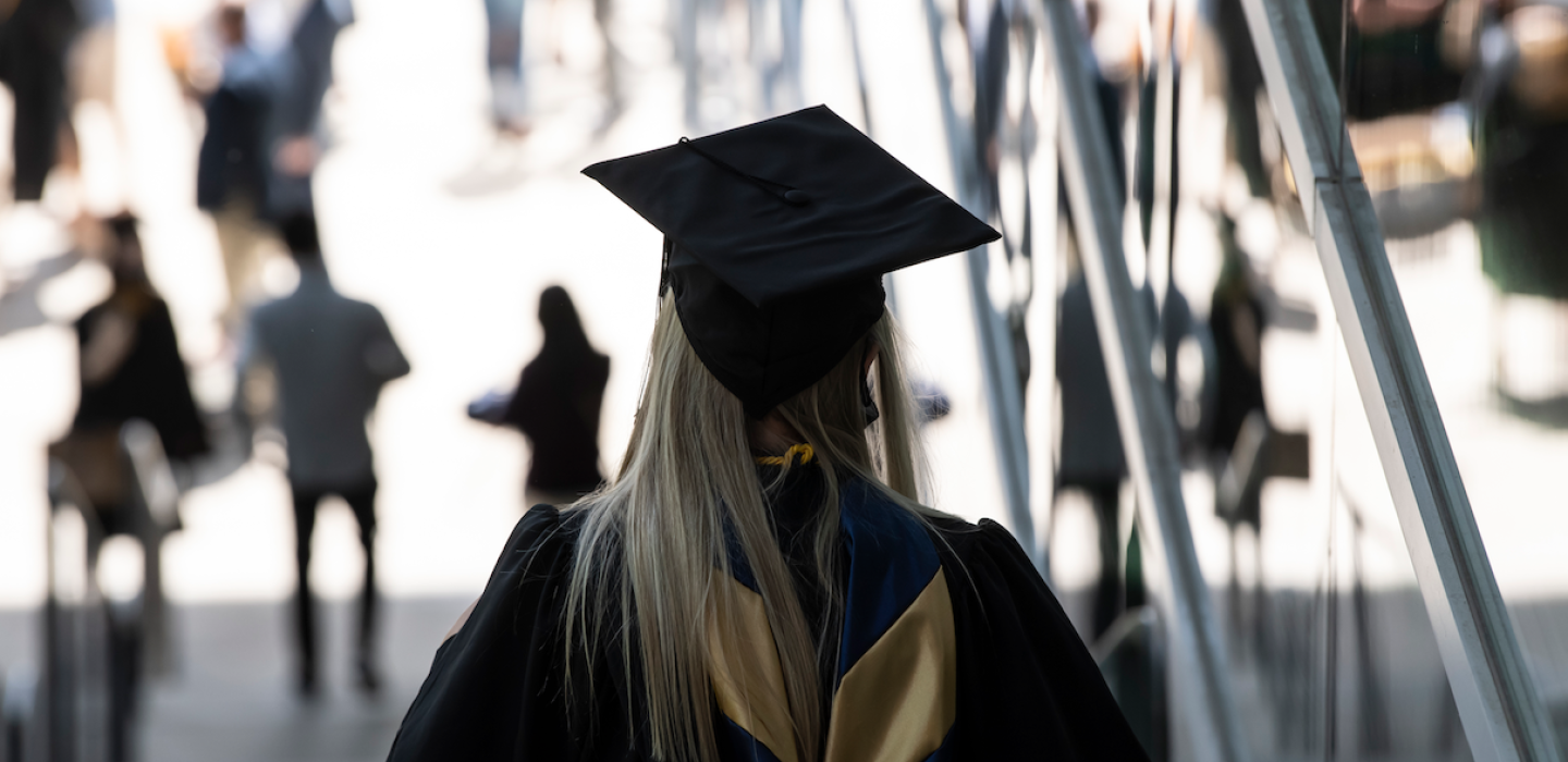 a person in a graduation cap from behind