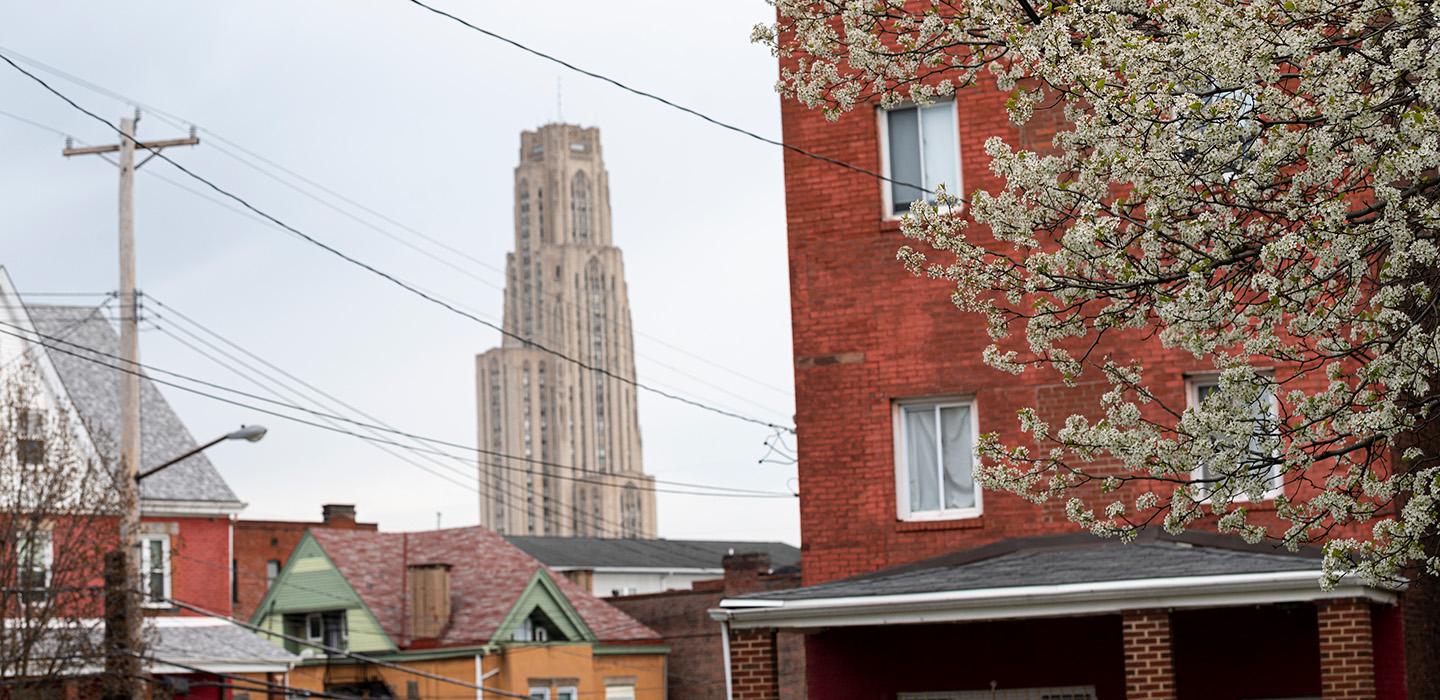 The Cathedral of Learning seen behind houses in the Oakland neighborhood
