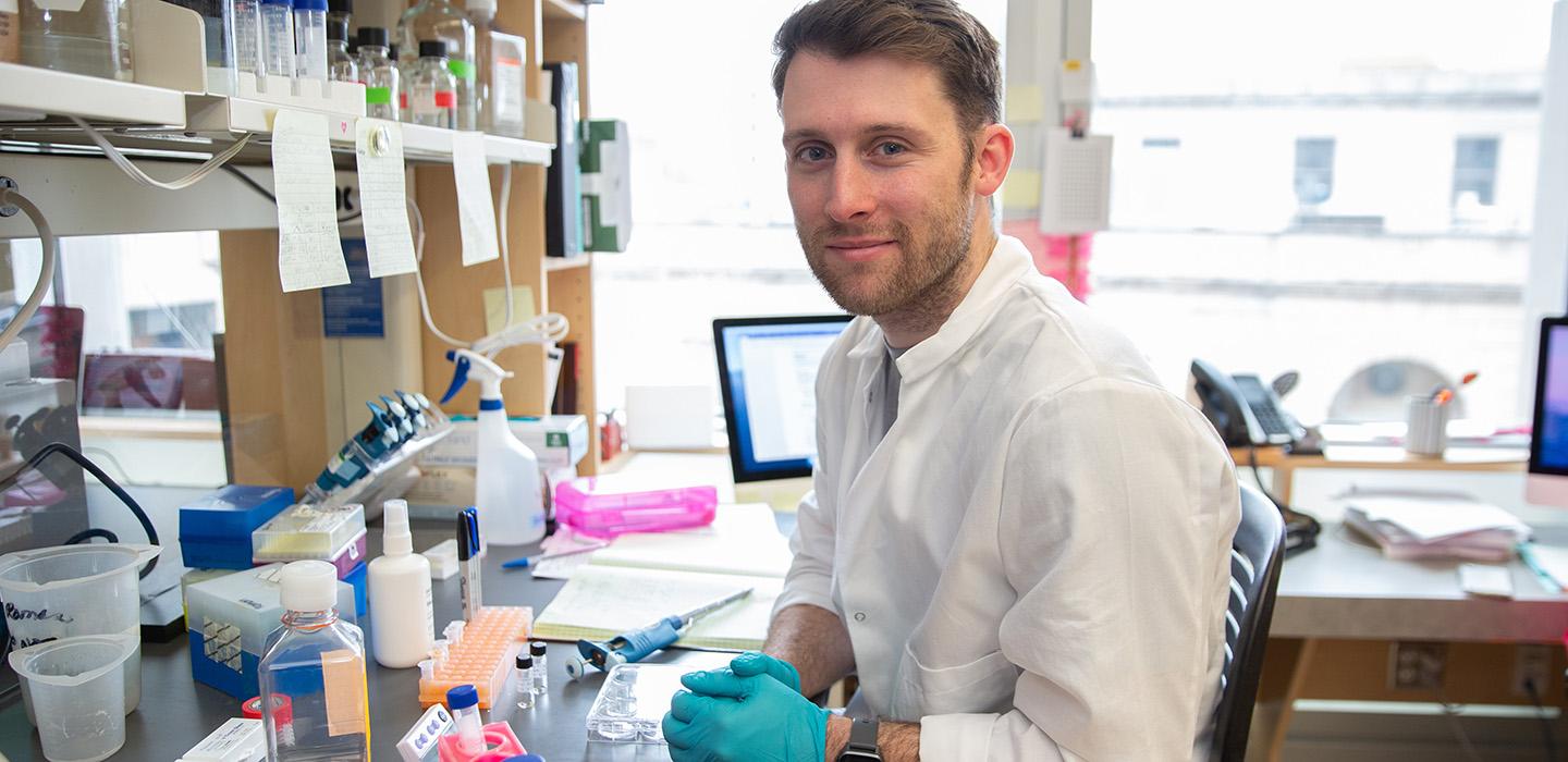 Anzell sits in a lab