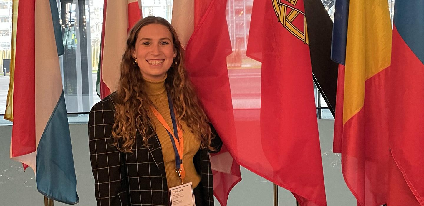 Furmansky in front of a row of flags