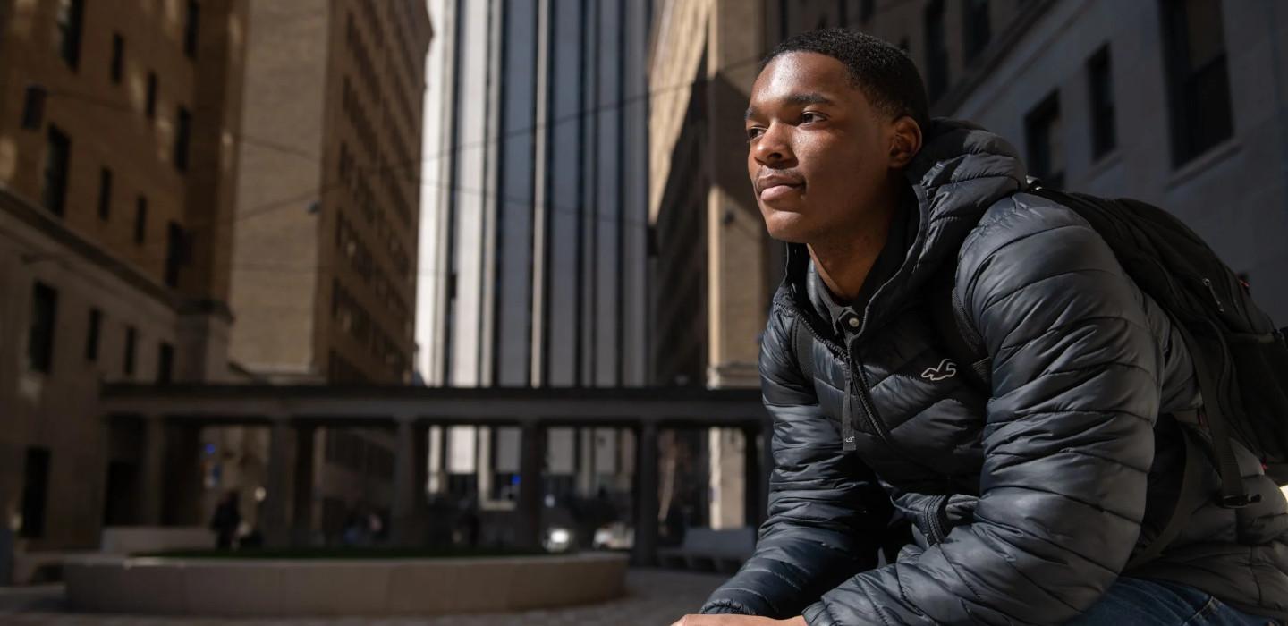 Xavier Littlejohn on the Pitt campus in a black jacket
