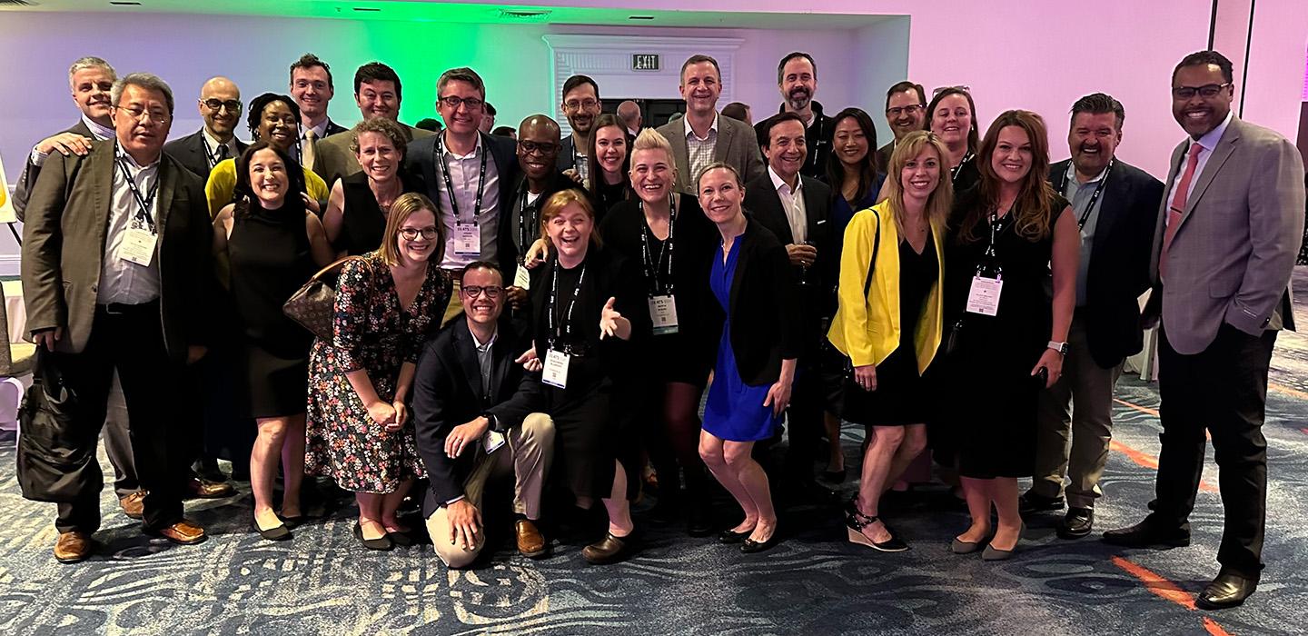 People pose at a conference