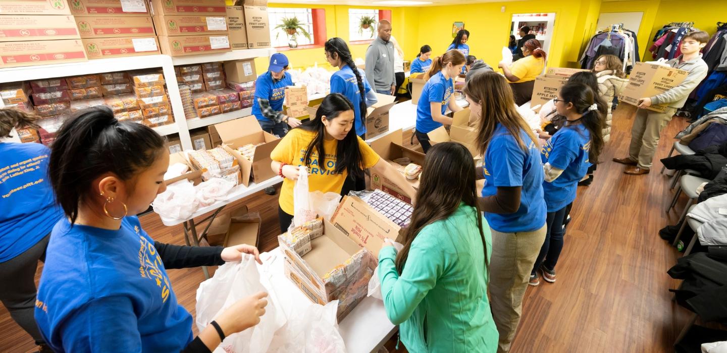 Pitt community members volunteer and bag items during MLK Day of service in the Hill District.