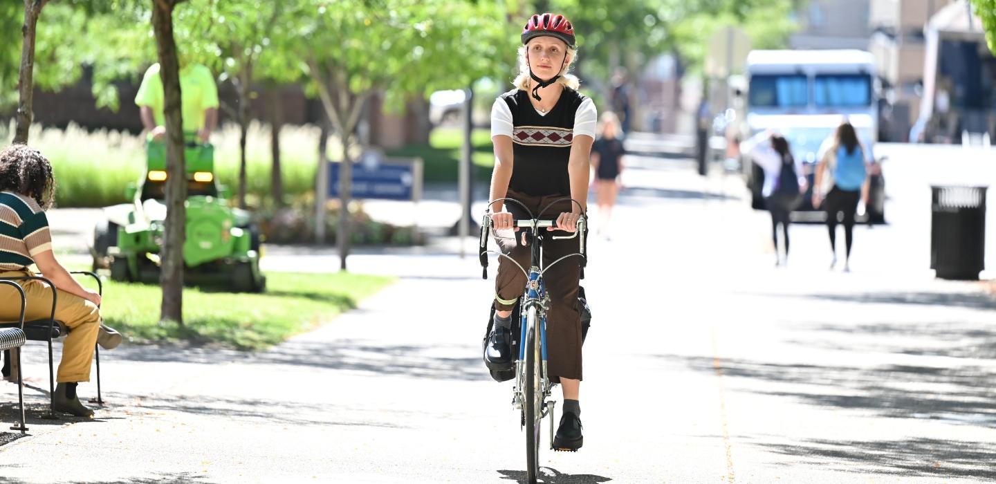 Pitt’s mobility specialist, Lucy Klug, rides her bike on campus.