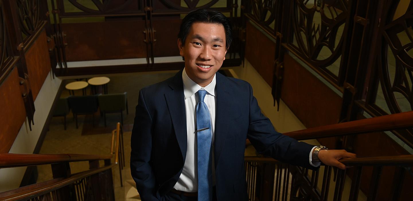 Fang on a staircase in the Honors College
