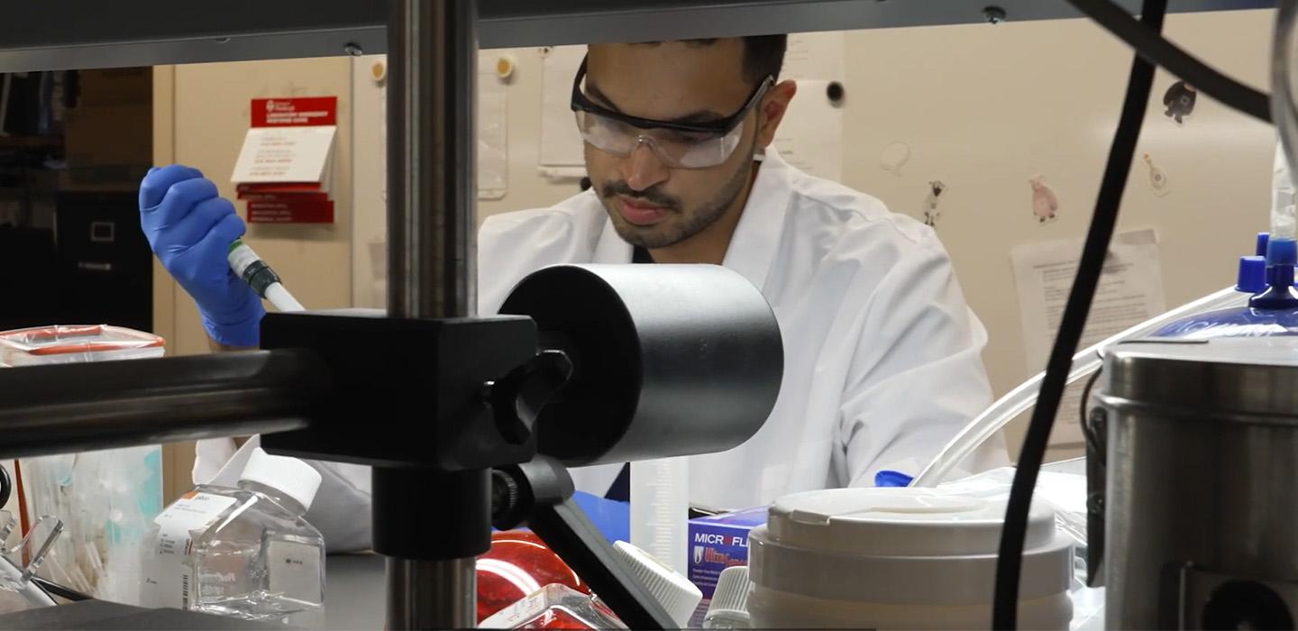 Adi Mittal pipetting in the lab 