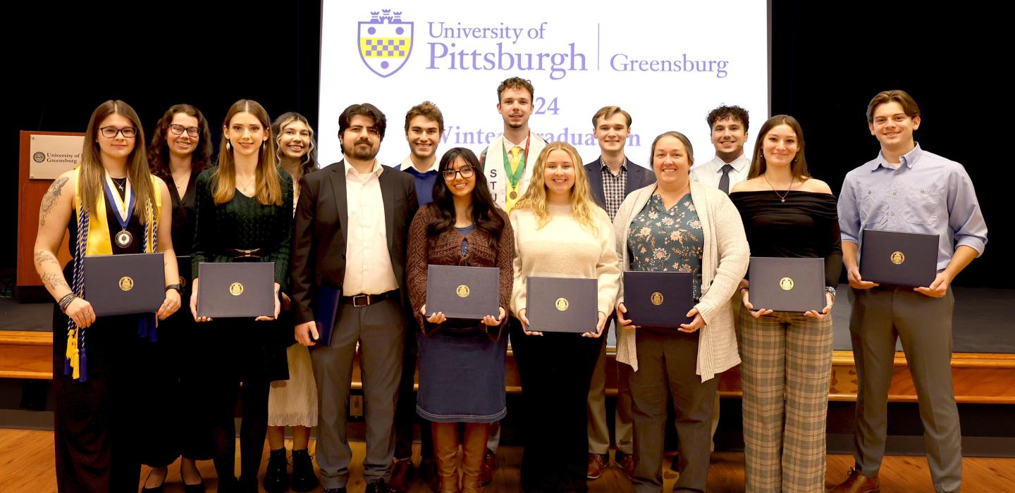 Pitt-Greensburg graduates pose for a portrait during the campus' first-ever winter commencement celebration. 