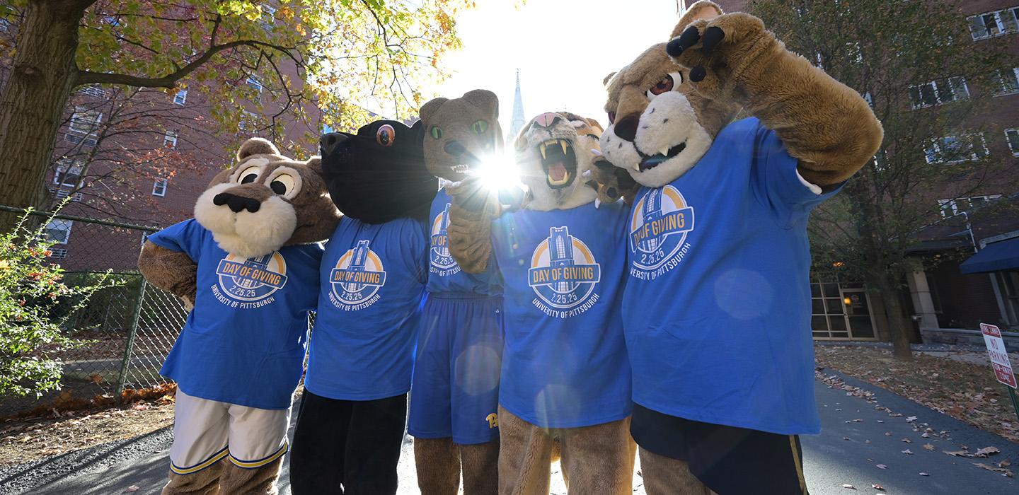 The five Pitt big cat mascots pose in Pitt Day of Giving shirts