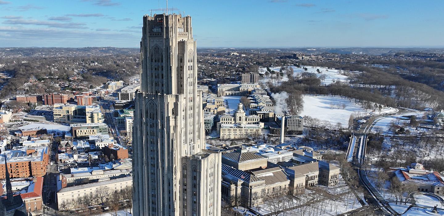 The Cathedral of Learning stands over the Oakland neighborhood on a snowy day