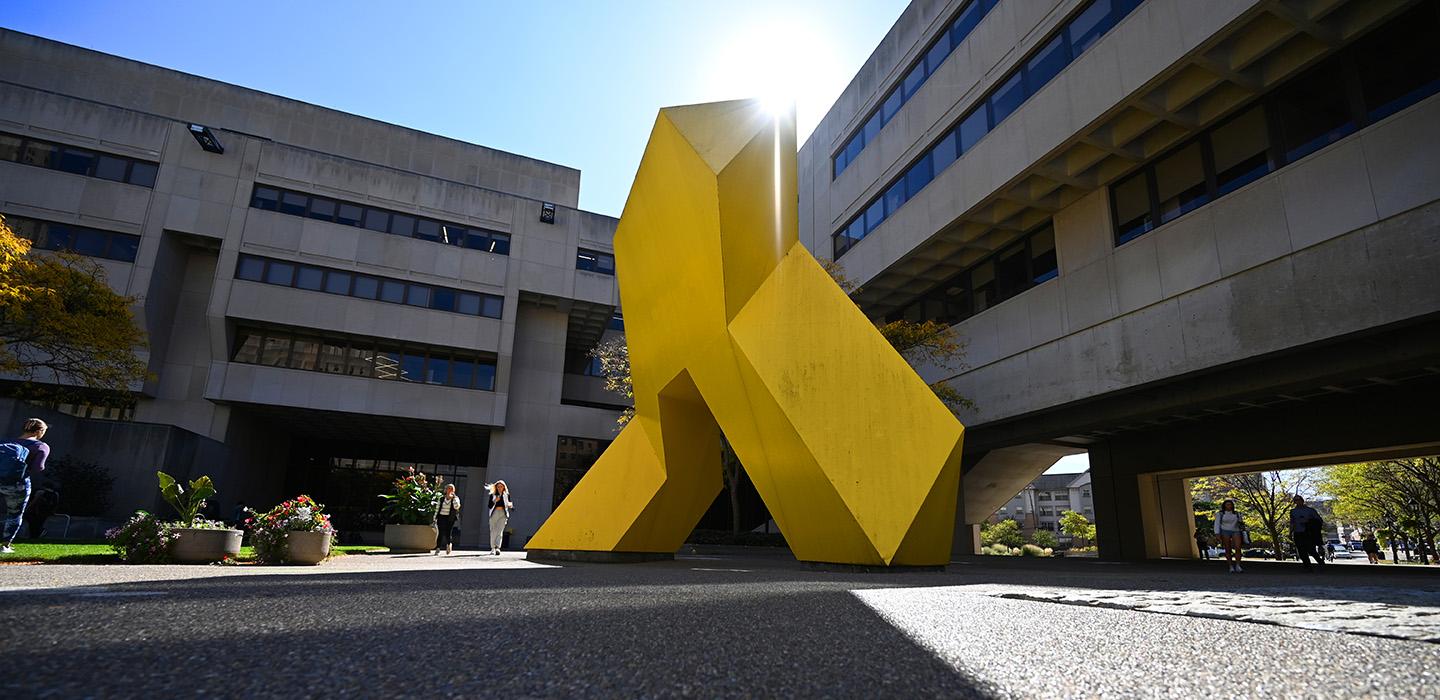 An abstract yellow sculpture outside Pitt's Posvar Hall 