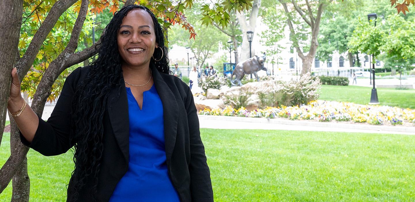 LaToya Walters in front of bronze panther statue