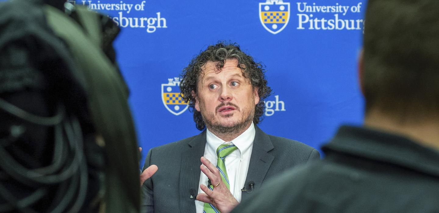Duprex in a suit and green tie