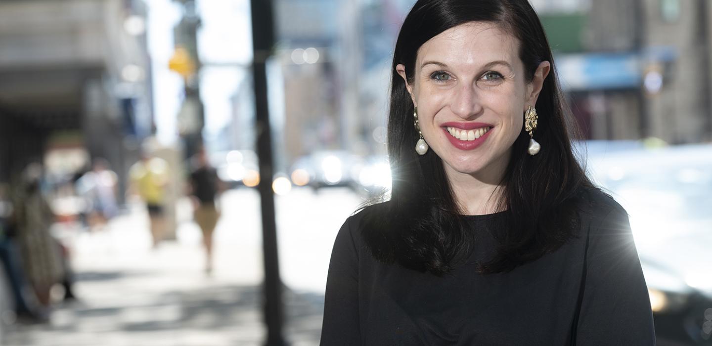 Eleanor Mattern in a black shirt, with a blurred out Oakland in the background