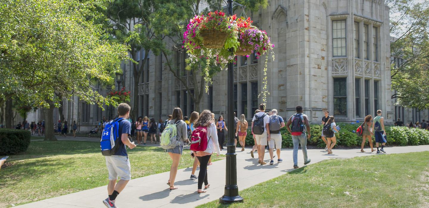 students walking on a sidewalk in front of the Cathedral