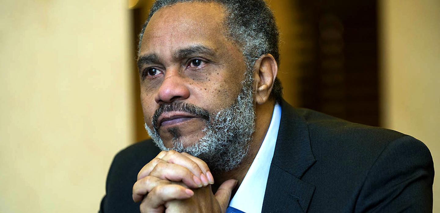 Anthony Ray Hilton in a black suit
