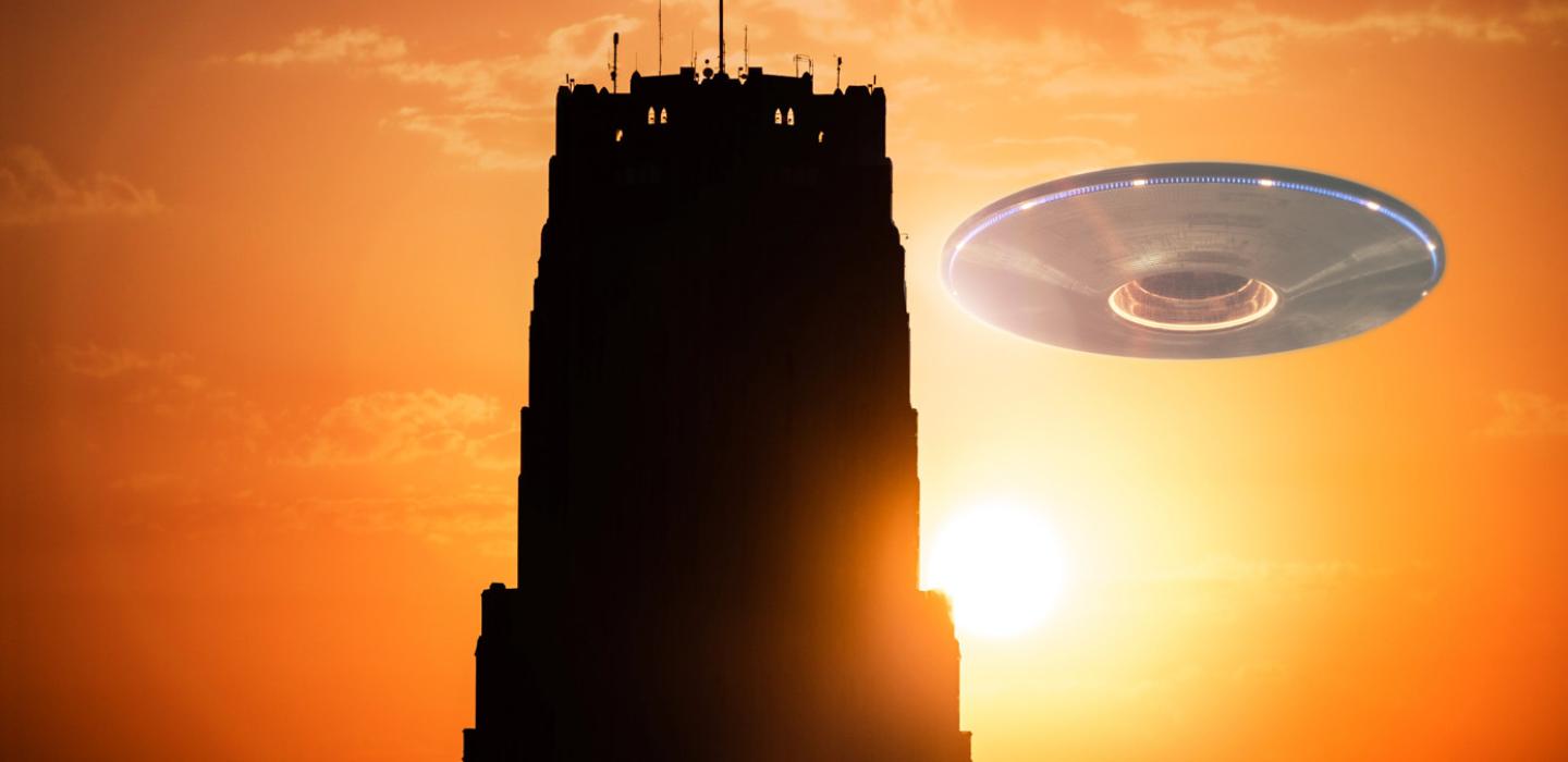 Cathedral of Learning at sunset with a flying saucer to the right