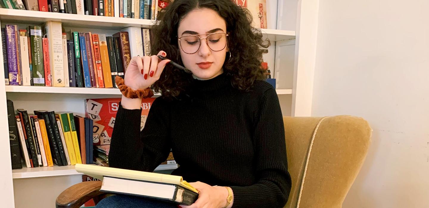 A woman with glasses in a dark shirt